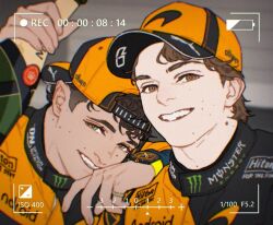  2boys arm_on_another's_shoulder arm_up backwards_hat baseball_cap black_hat black_jacket bottle brown_eyes brown_hair champagne_bottle commentary formula_one green_eyes grin hat holding holding_bottle jacket lando_norris logo long_sleeves looking_to_the_side male_focus mole mole_on_neck monster_energy multicolored_hat multicolored_jacket multiple_boys orange_hat orange_jacket oscar_piastri real_life short_hair short_sideburns sideburns sideways_glance skyleranderton smile sponsor teeth upper_body very_short_hair viewfinder watch watch wavy_hair 
