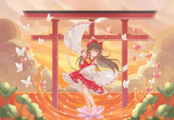  1girl ascot bow brown_hair bug butterfly closed_eyes closed_mouth clouds commentary dancing detached_sleeves dusk flower frilled_bow frilled_hair_tubes frills gohei hair_bow hair_tubes hakurei_reimu holding holding_gohei long_hair lotus red_bow red_skirt ribbon-trimmed_sleeves ribbon_trim shirt skirt skirt_set solo torii touhou touhou_lost_branch_of_legend vikramjoti water yellow_ascot 