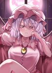  1girl bangs bat_wings closed_mouth frown full_moon hat highres indoors looking_at_viewer maboroshi_mochi mob_cap moon pink_headwear puffy_sleeves purple_hair red_eyes remilia_scarlet short_hair sitting solo touhou upper_body window wings 
