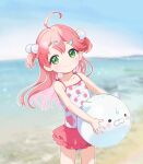  1girl aged_down ahoge ball bangs beach blurry blurry_background blush child day green_eyes hair_bobbles hair_ornament hairclip highres holding holding_ball hololive looking_at_viewer machico multicolored_hair one-piece_swimsuit outdoors pink_hair polka_dot polka_dot_swimsuit sakura_miko sky smile solo swimsuit two-tone_hair virtual_youtuber water 