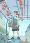  1girl absurdres apron bicycle box brown_eyes brown_hair building car day food full_body green_apron ground_vehicle highres holding holding_box holding_food katakai market medium_hair motor_vehicle onion original outdoors shoes solo standing 