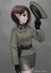  1girl 2022 artist_name belt black_gloves breast_pocket brown_belt brown_hair cross english_commentary glasses gloves grey_background grey_skirt hat highres holding holding_clothes holding_hat iron_cross looking_to_the_side mardjan military military_hat military_uniform original pocket pointy_ears pointy_nose round_eyewear short_hair skirt soldier uniform vampire 