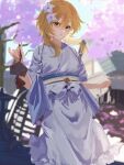  1girl blonde_hair cherry_blossoms ema flower genshin_impact hair_flower hair_ornament highres japanese_clothes kimono looking_at_viewer lumine_(genshin_impact) nakatsuka123 outdoors parted_lips short_hair_with_long_locks solo white_kimono yellow_eyes 