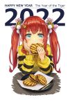  1girl 2022 animal_print bangs blue_eyes blush chinese_zodiac eating elbow_rest food food_request fukukitaru hair_ornament hair_ribbon hand_on_own_cheek hand_on_own_face happy_new_year highres holding holding_food long_hair long_sleeves looking_at_viewer nengajou new_year original plate pom_pom_(clothes) pom_pom_hair_ornament redhead ribbon smile solo sweater tiger_hair_ornament tiger_print twintails year_of_the_tiger 