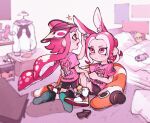  2girls animal_ear_fluff animal_ears backwards_hat bed bike_shorts black_shorts blanket cellphone closed_mouth clothes_hanger fang frown hand_on_another&#039;s_waist hat highres inari1369 indoors inkling inkling_girl kneeling looking_at_another multiple_girls octarian octoling octoling_girl orange_eyes phone pillow pink_eyes pink_hair pink_shirt pointy_ears rabbit_ears shelf shirt shoes short_sleeves shorts single_vertical_stripe sitting smartphone sparkle splatoon_(series) splatoon_2 stuffed_animal stuffed_toy suction_cups t-shirt tentacle_hair visor_cap 