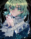  1girl bangs black_background capelet closed_mouth green_eyes green_hair highres juliet_sleeves light_particles long_sleeves looking_at_viewer naganegi own_hands_together puffy_sleeves short_hair soga_no_tojiko solo touhou upper_body white_capelet 
