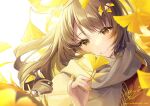 1girl bangs blush brown_eyes brown_hair ginkgo_leaf grey_scarf hand_up holding holding_leaf kagachi_saku leaf long_hair looking_at_viewer orange_shirt original parted_lips scarf shirt signature smile solo