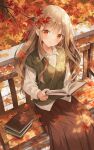  1girl :o autumn autumn_leaves bangs blurry blurry_background blush book collared_shirt falling_leaves green_vest highres holding holding_book leaf light_brown_hair long_hair long_sleeves looking_at_viewer multicolored_eyes orange_eyes original outdoors pleated_skirt reading red_skirt shiny shiny_hair shirt sitting sitting_on_bench skirt solo stone_floor tree vest weri white_shirt 