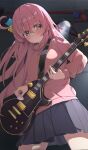  1girl band_(skymole01) bangs black_skirt blue_eyes blush bocchi_the_rock! closed_mouth commentary cowboy_shot cube_hair_ornament electric_guitar english_commentary facing_viewer from_below gotou_hitori green_eyes guitar hair_between_eyes hair_ornament hair_over_eyes highres holding holding_instrument indoors instrument jacket lips long_hair long_sleeves looking_away multicolored_eyes music one_side_up pink_hair pink_jacket playing_instrument pleated_skirt plectrum skirt solo spotlight standing sweat track_jacket 