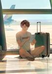  1boy aircraft airplane airport blue_shorts brown_hair crossed_legs full_body haikyuu!! highres holding holding_tablet_pc hq_yunak indoors male_focus oikawa_tooru_(haikyuu!!) shirt short_hair short_sleeves shorts sitting solo suitcase t-shirt tablet_pc white_shirt 