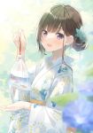  1girl :d amamine animal bag bagged_fish bangs black_hair blue_flower blurry blurry_foreground commentary_request day depth_of_field fish floral_print flower goldfish hair_bun hair_flower hair_ornament holding japanese_clothes kimono long_sleeves looking_at_viewer original outdoors print_kimono smile solo violet_eyes water white_kimono wide_sleeves 