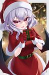  1girl :d absurdres bat_wings belt blurry blurry_background border box capelet christmas christmas_tree dress fangs gift gift_box hat highres holding holding_gift looking_at_viewer open_mouth purple_hair red_capelet red_dress red_eyes red_headwear remilia_scarlet s_vileblood santa_costume santa_hat skin_fangs smile solo touhou white_border wings 