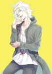  1boy black_pants collarbone cowboy_shot cropped_legs danganronpa_(series) danganronpa_2:_goodbye_despair evil_smile green_eyes green_jacket haruba_negi head_tilt highres hood hood_down hooded_jacket jacket komaeda_nagito long_jacket looking_at_viewer messy_hair open_mouth pale_skin pants shirt simple_background smile smug solo wavy_hair white_hair white_shirt yellow_background zipper 