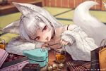  1girl animal_ear_fluff animal_ears aqua_nails arm_rest artist_name bag bangs bare_shoulders black_choker blurry box box_of_chocolates chocolate choker commentary cup dated depth_of_field drink fox_ears fox_tail head_rest head_tilt heart-shaped_box highres indoors kotatsu long_sleeves looking_at_viewer nail_polish off-shoulder_sweater off_shoulder original piercing red_eyes shopping_bag signature sleeves_past_wrists solo suzuno_(bookshelf) sweater symbol-only_commentary table tail tatami thick_eyebrows tongue tongue_out tongue_piercing white_hair 