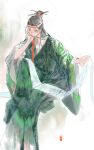  1boy black_hair chinese_clothes clothes_writing eyeliner feet_out_of_frame green_robe hair_pulled_back half_updo hand_on_own_cheek hand_on_own_face hand_up hanfu hanging_scroll head_rest highres holding holding_scroll knee_up long_sleeves looking_at_viewer maid_headdress makeup mouth_hold one_hundred_scenes_of_jiangnan outstretched_arm paintbrush paintbrush_hair_ornament red_ribbon ribbon robe scroll shen_zhou sideways_glance simple_background sitting solo white_background wide_sleeves yinertang 