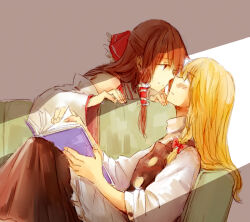  2girls apron bigreen black_skirt black_vest blush book bow brown_eyes brown_hair commentary couch detached_sleeves eye_contact frilled_bow frilled_hair_tubes frills hair_bow hair_tubes hakurei_reimu holding holding_book kirisame_marisa long_hair long_sleeves looking_at_another multiple_girls no_headwear on_couch red_bow ribbon-trimmed_sleeves ribbon_trim skirt touhou vest waist_apron white_apron yuri 