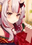  1girl absurdres bell blurry blurry_background blush depth_of_field double_bun frilled_sleeves frills hair_bell hair_bun hair_ornament hand_up highres hololive horns jingle_bell long_hair looking_at_viewer multicolored_hair nakiri_ayame oni oni_horns pom_pom_(clothes) red_eyes redhead sidelocks skin-covered_horns solo streaked_hair tassel tassel_hair_ornament virtual_youtuber white_hair yomogi_uehara 