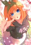  1girl :o absurdres black_hoodie blue_eyes blurry blush cherry_blossoms clothes_writing commentary dappled_sunlight depth_of_field eyebrows_hidden_by_hair falling_petals foreshortening from_above go-toubun_no_hanayome green_hairband green_ribbon hair_between_eyes hair_ribbon hairband highres hood hood_down hoodie light_particles long_sleeves looking_at_viewer medium_hair nakano_yotsuba open_hand open_mouth orange_hair petal_on_face petals reaching_towards_viewer ribbon solo sparkling_eyes straight_hair sunlight tamago_sando wide-eyed 