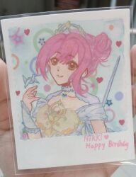  1girl absurdres armor artist's_hand_in_frame blue_background blue_gemstone breastplate brooch brown_eyes character_name chest_jewel closed_mouth collar collarbone detached_collar dot_nose dress english_text eyelashes gem hair_between_eyes hair_bun hand_up happy happy_birthday heart heart_brooch highres infinity_nikki jewelry lace_collar lips looking_at_viewer melody_bloom_(infinity_nikki) nikki_(nikki) nikki_(series) object_floating_above_hand off-shoulder_dress off_shoulder origami painting_(medium) paper_crane photo_(medium) pink_hair pink_lips polka_dot polka_dot_background short_hair_with_long_locks short_sleeves single_side_bun single_sidelock smile solo star_(symbol) sue78218 sword sword_on_back tiara traditional_media updo upper_body weapon weapon_on_back white_collar white_dress 