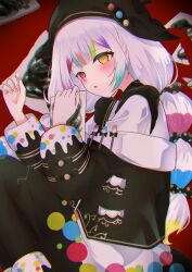  1girl absurdres beret black_jacket black_pantyhose bow chromatic_aberration commentary_request feet_out_of_frame hat heterochromia highres holding holding_paper jacket jogasaki_noah long_hair long_sleeves looking_at_viewer lying mahou_shoujo_no_majo_saiban maririnn1212 multi-tied_hair multicolored_hair neck_ribbon on_side paintbrush pantyhose paper pink_eyes polka_dot polka_dot_bow red_background ribbon solo streaked_hair white_hair yellow_eyes 