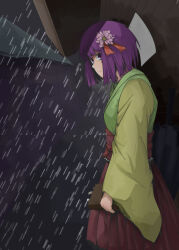  1girl closed_mouth commentary_request cowboy_shot flower from_side green_kimono hair_flower hair_ornament hakama hakama_skirt hieda_no_akyuu highres house hunched_over japanese_clothes kimono looking_at_viewer outdoors pi-nattus pink_flower pleated_skirt purple_hair rain red_skirt short_hair sideways_glance skirt solo standing touhou yellow_kimono 