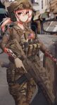  1girl american_flag assault_rifle blonde_hair blurry blurry_background brown_headwear brown_jacket brown_pants building camouflage camouflage_headwear camouflage_pants car closed_mouth dausagi day depth_of_field feet_out_of_frame gun h&amp;k_hk416 hair_between_eyes helmet highres jacket long_hair looking_at_viewer motor_vehicle original outdoors pants ponytail red_eyes rifle scope side_mirror solo standing weapon 