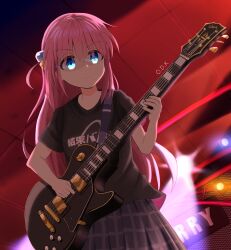  1girl absurdres backlighting black_shirt blue_eyes bocchi_the_rock! closed_mouth clothes_writing commentary_request cowboy_shot cube_hair_ornament eyes_visible_through_hair gotoh_hitori grey_skirt guitar hair_between_eyes hair_ornament highres holding holding_guitar holding_instrument indoors instrument long_hair odk_360 one_side_up pink_hair plaid_clothes plaid_skirt playing_guitar playing_instrument pleated_skirt shirt short_sleeves sidelocks skirt solo split_mouth spotlight stage t-shirt tareme v-shaped_eyebrows very_long_hair 