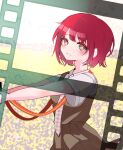  1girl :d blurry blurry_background blush bob_cut breasts bright_pupils brown_dress brown_eyes camera commentary danganronpa_(series) danganronpa_2:_goodbye_despair depth_of_field dress dress_shirt eyelashes field film_strip freckles from_side highres holding holding_camera koizumi_mahiru komatta_nagito looking_at_viewer looking_to_the_side messy_hair necktie outdoors outstretched_arms parted_lips pinafore_dress plaid_necktie red_necktie redhead school_uniform shirt short_hair short_sleeves sleeveless sleeveless_dress small_breasts smile solo standing strap two-tone_necktie upper_body very_short_hair white_necktie white_pupils white_shirt wind 