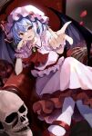  1girl blue_hair crossed_legs falling_petals flower hat highres hyurasan looking_at_viewer mob_cap petals pink_headwear pink_shirt pink_skirt pointing pointing_at_viewer red_eyes red_flower red_footwear red_rose remilia_scarlet rose shirt short_hair sitting skirt skull smile solo touhou 