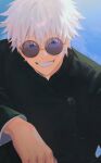  1boy absurdres black_jacket blue_eyes day gojou_satoru grin highres jacket jujutsu_kaisen jujutsu_tech_uniform long_sleeves looking_at_viewer male_focus outdoors round_eyewear school_uniform sebin_13 short_hair smile solo sunglasses teeth upper_body v-shaped_eyebrows white_hair 