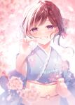  1girl amamine blue_kimono blurry blurry_background blurry_foreground blush brown_hair commentary_request depth_of_field flower grin holding holding_flower japanese_clothes kimono long_sleeves looking_at_viewer obi original pink_flower sash smile solo swept_bangs upper_body violet_eyes wide_sleeves 