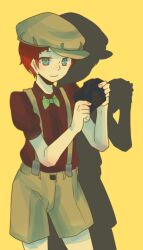  1girl alternate_costume androgynous bow bowtie camera closed_mouth commentary_request cowboy_shot danganronpa_(series) danganronpa_2:_goodbye_despair drop_shadow freckles green_bow green_bowtie green_eyes green_hat green_shorts hat holding holding_camera koizumi_mahiru red_hair red_shirt reverse_trap shinshishinc shirt short_hair short_sleeves shorts simple_background smile solo suspenders very_short_hair yellow_background 