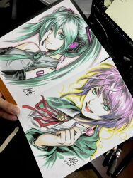  1boy 1girl amemura_ramuda art_tools_in_frame artist's_hand_in_frame candy closed_mouth commentary cropped_torso detached_sleeves english_commentary food green_eyes green_hair green_jacket green_necktie grey_shirt hatsune_miku headset highres holding holding_candy holding_food holding_lollipop hypnosis_mic jacket lollipop looking_at_viewer marker_(medium) necktie number_tattoo open_mouth photo_(medium) purple_hair shirt signature sleeveless smile stanley_lau tattoo teeth traditional_media twintails upper_teeth_only vocaloid 