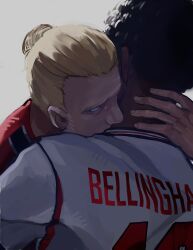  2026_fifa_world_cup 2boys absurdres back black_hair blonde_hair blue_eyes commentary english_national_soccer_team_uniform erling_haaland hair_bun highres hug jude_bellingham luzxxiii multiple_boys norwegian_national_soccer_team_uniform real_life simple_background soccer_uniform sportswear upper_body world_cup 