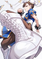  1girl boots bracelet breasts brown_eyes brown_hair bun_cover china_dress chinese_clothes chun-li commentary_request double_bun dress earrings hair_bun highres jewelry kicking looking_at_viewer medium_breasts pantyhose pelvic_curtain short_hair spiked_bracelet spikes street_fighter street_fighter_ii_(series) thighs white_boots yagi2013 