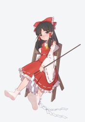  1girl absurdres ascot blush bow brown_eyes brown_hair chair chinese_commentary commentary_request detached_sleeves embarrassed frilled_bow frilled_hair_tubes frilled_skirt frills full_body gohei grey_background hair_bow hair_tubes hakurei_reimu highres holding holding_gohei long_hair looking_at_viewer nekoharayuzuki on_chair red_bow red_skirt ribbon-trimmed_skirt ribbon-trimmed_sleeves ribbon_trim simple_background sitting skirt skirt_set socks solo touhou white_socks yellow_ascot 