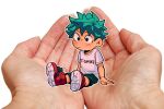 1boy boku_no_hero_academia closed_mouth clothes_writing commentary cupping_hands english_commentary freckles full_body green_eyes green_hair habkart in_palm male_focus midoriya_izuku mini_person miniboy outline own_hands_together photo_background red_footwear shirt shoes short_hair short_sleeves shorts simple_background sitting sitting_on_hand t-shirt white_background white_outline white_shirt 