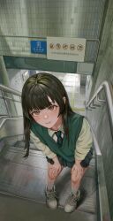  1girl absurdres black_hair black_skirt brown_eyes commentary_request green_vest hands_on_own_knees highres leaning_forward long_hair looking_at_viewer looking_up mole mole_on_cheek on_stairs original parted_lips pleated_skirt scenery school_uniform shoes skirt socks solo stairs standing subway_station user_vvdr2237 vest white_shoes white_socks 