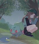  1girl 343rone bike_shorts black_footwear brown_eyes brown_hair bulbasaur bush closed_mouth commentary_request dress green_headwear green_jacket hair_flaps hand_up hat highres jacket leaf_(pokemon) leaf_(sygna_suit)_(pokemon) long_hair long_sleeves lotad official_alternate_costume outdoors pink_dress pokemon pokemon_(creature) pokemon_(game) pokemon_masters_ex rain shoes sidelocks squatting tree water 