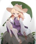  1girl absurdres animal_print blonde_hair brown_headwear closed_mouth commentary frog_print full_body hat highres holding holding_leaf kani_nyan knees_up leaf long_hair long_sleeves looking_at_viewer moriya_suwako purple_skirt purple_vest rock sandals sitting skirt smile solo thigh-highs touhou turtleneck vest white_thighhighs wide_sleeves yellow_eyes 