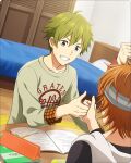  2boys akiyama_hayato bed bed_sheet book fingernails green_hair hair_between_eyes headband idolmaster idolmaster_side-m idolmaster_side-m_growing_stars male_focus multiple_boys official_art open_book orange_hair out_of_frame pencil shirt smile table teeth thumb_war wakazato_haruna 