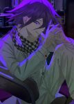  1boy artist_name checkered_clothes checkered_scarf danganronpa_(series) danganronpa_v3:_killing_harmony flipped_hair grey_jacket grey_pants grin hair_between_eyes hands_up highres indoors jacket long_sleeves male_focus multicolored_background oma_kokichi own_hands_together pants purple_hair scarf smile solo teeth very_fruity 
