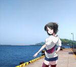  1girl alternate_costume belt_bag black_hair black_thighhighs blue_shorts blue_sky brown_eyes clouds cowboy_shot day denim denim_shorts dock from_behind horizon kantai_collection kimura_shiki looking_at_viewer looking_back mountain nagara_(kancolle) ocean one_side_up outdoors photo_background shirt short_hair shorts sky solo standing t-shirt thigh-highs water white_shirt 