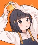  1girl 1ssakawaguchi arms_up black_hair blunt_bangs blush bob_cut brown_eyes gift hair_ornament hairclip highres holding holding_gift long_sleeves looking_at_viewer open_mouth orange_background original overalls short_hair simple_background upper_body valentine 