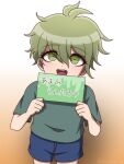  1boy :d aged_down amami_rantaro blue_shorts brown_background cowboy_shot danganronpa_(series) danganronpa_v3:_killing_harmony gradient_background green_eyes green_hair grey_shirt hair_between_eyes hands_up highres holding holding_sign male_focus messy_hair shirt short_hair short_sleeves shorts sign smile solo suiren_yurei teeth translation_request upper_teeth_only 