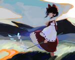  1girl ascot black_hair blush bow closed_mouth day detached_sleeves gohei grass hair_bow hair_tubes hakurei_reimu holding kawatiw looking_at_viewer outdoors red_bow red_skirt ribbon-trimmed_sleeves ribbon_trim skirt skirt_set solo standing touhou wide_sleeves yellow_ascot 