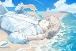  1boy beach blue_eyes fate/grand_order fate_(series) food highres holding holding_food holding_popsicle long_sleeves looking_at_viewer lying male_focus medium_hair nuehnana oberon_(fate) official_alternate_costume on_back popsicle sand sky smile solo upper_body 