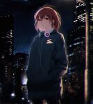  1girl black_hoodie brown_eyes brown_hair building character_request closed_mouth commentary_request copyright_request cowboy_shot hands_in_pockets headphones headphones_around_neck highres hood hoodie lamppost long_sleeves looking_at_viewer night night_sky out_type_(outtypeex) outdoors short_hair sky skyscraper solo standing 