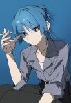 1girl aged_up black_pants blue_background blue_hair blue_shirt bocchi_the_rock! chorohanage cigarette closed_mouth collarbone collared_shirt commentary_request eyes_visible_through_hair highres holding holding_cigarette looking_at_viewer mole mole_under_eye pants shirt short_hair simple_background sleeves_rolled_up solo yamada_ryo yellow_eyes 