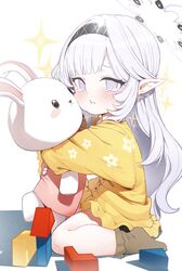  1girl absurdres aged_down blue_archive child closed_mouth crying crying_with_eyes_open dress frown halo highres himari_(blue_archive) kneeling long_hair looking_at_viewer object_hug pointy_ears pout sitting socks solo stuffed_animal stuffed_toy tears violet_eyes white_hair yellow_dress zanya_000 